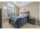 Well-lit bedroom with carpet, a ceiling fan, large windows, and a bed with decorative pillows at 127 Willow Bay Dr., Murrells Inlet, SC 29576