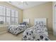 Bright bedroom featuring carpet, twin beds, a ceiling fan, and shuttered windows at 127 Willow Bay Dr., Murrells Inlet, SC 29576