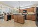 Bright kitchen featuring a center island, black appliances, and wood cabinetry at 127 Willow Bay Dr., Murrells Inlet, SC 29576
