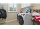 Laundry room featuring white cabinets and a front load washer and dryer at 127 Willow Bay Dr., Murrells Inlet, SC 29576