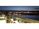 Nighttime waterfront view from the boardwalk featuring lights reflecting in the water at 127 Willow Bay Dr., Murrells Inlet, SC 29576