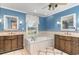 Bathroom featuring a jacuzzi tub, dual vanities, tile accents, mirrors and nice lighting at 128 Causey St., Myrtle Beach, SC 29577