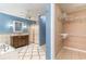 Bathroom featuring an ornate vanity, tiled floor, walk-in shower, jacuzzi, and walk-in closet at 128 Causey St., Myrtle Beach, SC 29577