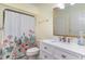 Clean bathroom featuring floral shower curtain, white vanity and quartz countertop with sink at 128 Causey St., Myrtle Beach, SC 29577
