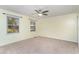 Neutral bedroom featuring two windows, neutral carpet, ceiling fan and neutral paint at 128 Causey St., Myrtle Beach, SC 29577