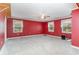 Bedroom with carpeted floor, ceiling fan, and three windows, painted red at 128 Causey St., Myrtle Beach, SC 29577
