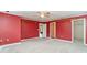 Spacious bedroom featuring neutral carpet, ceiling fan, and doorways to hall and walk-in closet at 128 Causey St., Myrtle Beach, SC 29577