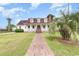 Charming white two-story home with a red roof, solar panels, and a welcoming front porch at 128 Causey St., Myrtle Beach, SC 29577