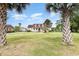 Charming home with a manicured lawn, and lovely curb appeal set among mature palm trees at 128 Causey St., Myrtle Beach, SC 29577