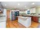 Well-lit kitchen with stainless steel appliances, a center island, and custom cabinetry at 128 Causey St., Myrtle Beach, SC 29577