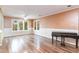 Bright living room with hardwood floors, large windows, and a classic piano at 128 Causey St., Myrtle Beach, SC 29577