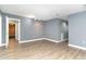 The living room has vinyl floors, gray walls, white trim, and a doorway to another room at 128 Causey St., Myrtle Beach, SC 29577