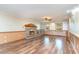 Spacious living room with a brick fireplace, hardwood floors, and natural light from large windows at 128 Causey St., Myrtle Beach, SC 29577