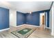 The living room has vinyl floors, blue accent walls, and a rug at 128 Causey St., Myrtle Beach, SC 29577