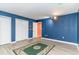 A living room with vinyl floors, blue walls, white trim, and a rug at 128 Causey St., Myrtle Beach, SC 29577