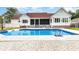 Backyard swimming pool features a spacious patio, and a view of the well-maintained white home at 128 Causey St., Myrtle Beach, SC 29577