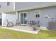 A fenced-in backyard with a concrete patio with rocking chairs and table and lawn at 136 Villa Grande St. # B, Myrtle Beach, SC 29579