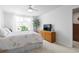 Comfortable bedroom with a floral comforter, large window, and natural light at 136 Villa Grande St. # B, Myrtle Beach, SC 29579