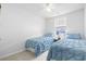Bright bedroom featuring two twin beds with blue bedding and a window view at 136 Villa Grande St. # B, Myrtle Beach, SC 29579