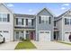 Charming townhome featuring well-maintained landscaping, a red front door, and an attached garage at 136 Villa Grande St. # B, Myrtle Beach, SC 29579