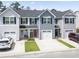 Townhome front exterior featuring driveway, garage, walkway, lawn, and colorful front door at 136 Villa Grande St. # B, Myrtle Beach, SC 29579