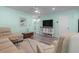 Bright living room featuring a cozy sofa, entertainment center, and staircase view at 136 Villa Grande St. # B, Myrtle Beach, SC 29579