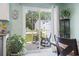 Dining area with open patio door and view to an outdoor patio, chairs, and manicured lawn at 136 Villa Grande St. # B, Myrtle Beach, SC 29579