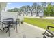 Outdoor patio area with dining set and chairs, with lawn and other townhomes nearby at 136 Villa Grande St. # B, Myrtle Beach, SC 29579