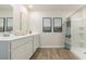 Bright bathroom featuring a double sink vanity, framed mirrors, and a walk-in shower at 152 Ashworth Dr., Tabor City, NC 28463