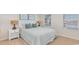 Cozy bedroom with a striped bedspread, matching lamps, and a sunlit window at 152 Ashworth Dr., Tabor City, NC 28463