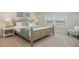 Serene bedroom with a wooden bed frame, neutral tones, and a comfortable seating area at 152 Ashworth Dr., Tabor City, NC 28463