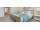 Comfortable bedroom featuring a wooden bed frame, soft lighting, and neutral carpeting at 152 Ashworth Dr., Tabor City, NC 28463