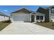 Charming single-story home with a white facade, attached garage, and well-maintained landscaping at 152 Ashworth Dr., Tabor City, NC 28463