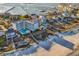 Aerial view of condo complex with neighboring beachfront homes, private pools, and boardwalks at 1581 S Waccamaw Dr. # 302, Garden City Beach, SC 29576