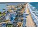 Aerial view of waterfront condo complex with ocean access and neighboring beachfront homes at 1581 S Waccamaw Dr. # 302, Garden City Beach, SC 29576