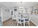 Charming dining area featuring white table, chairs, and stylish decor at 1581 S Waccamaw Dr. # 302, Garden City Beach, SC 29576