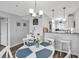 Bright dining area with stylish lighting and a view of the kitchen at 1581 S Waccamaw Dr. # 302, Garden City Beach, SC 29576