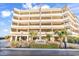 View of the condo's exterior with multiple floors, parking garage, and signage at 1581 S Waccamaw Dr. # 302, Garden City Beach, SC 29576