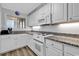 Bright kitchen with white cabinets, granite counters, and modern appliances at 1581 S Waccamaw Dr. # 302, Garden City Beach, SC 29576