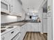 Bright kitchen features white cabinets, granite countertops, and stainless steel appliances at 1581 S Waccamaw Dr. # 302, Garden City Beach, SC 29576