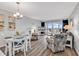 Bright living room with ocean view, modern furniture, and dining table at 1581 S Waccamaw Dr. # 302, Garden City Beach, SC 29576