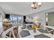 Cozy living room and dining area combo with ocean views and balcony access at 1581 S Waccamaw Dr. # 302, Garden City Beach, SC 29576