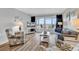 Bright living room with ocean views, balcony access, and coastal-themed decor at 1581 S Waccamaw Dr. # 302, Garden City Beach, SC 29576
