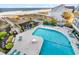 Beautiful pool with beach access, surrounded by lush landscaping and comfortable lounge seating at 1581 S Waccamaw Dr. # 302, Garden City Beach, SC 29576