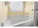 Bright bathroom with a relaxing jacuzzi tub under a window at 162 Jessica Lakes Dr., Conway, SC 29526