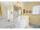 Well-lit bathroom featuring double sinks, white cabinets, and decorative mirrors at 162 Jessica Lakes Dr., Conway, SC 29526