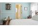Bright bedroom featuring wood floors, blue walls, and an attached bathroom at 162 Jessica Lakes Dr., Conway, SC 29526