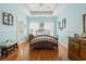 This primary bedroom boasts a tray ceiling, wood floors, and decorative accents at 162 Jessica Lakes Dr., Conway, SC 29526