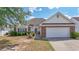 Charming single-story home with well-manicured lawn, brick accents, and attached two-car garage at 162 Jessica Lakes Dr., Conway, SC 29526