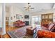 A cozy living room featuring a fireplace, ceiling fan and hardwood flooring at 162 Jessica Lakes Dr., Conway, SC 29526